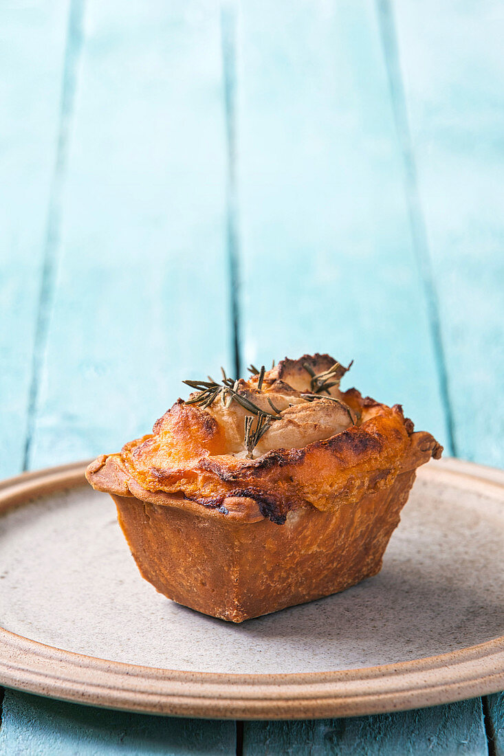 Individual cottage pie garnished with rosemary