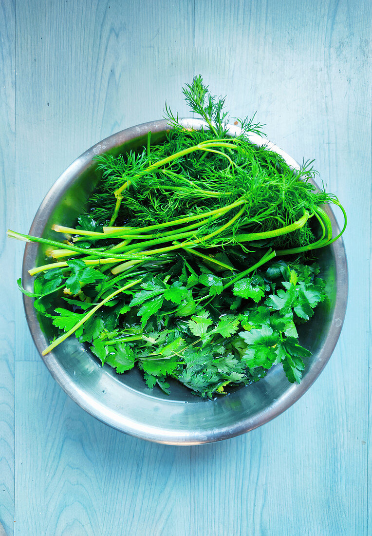 Fresh herbs in a metal bowl