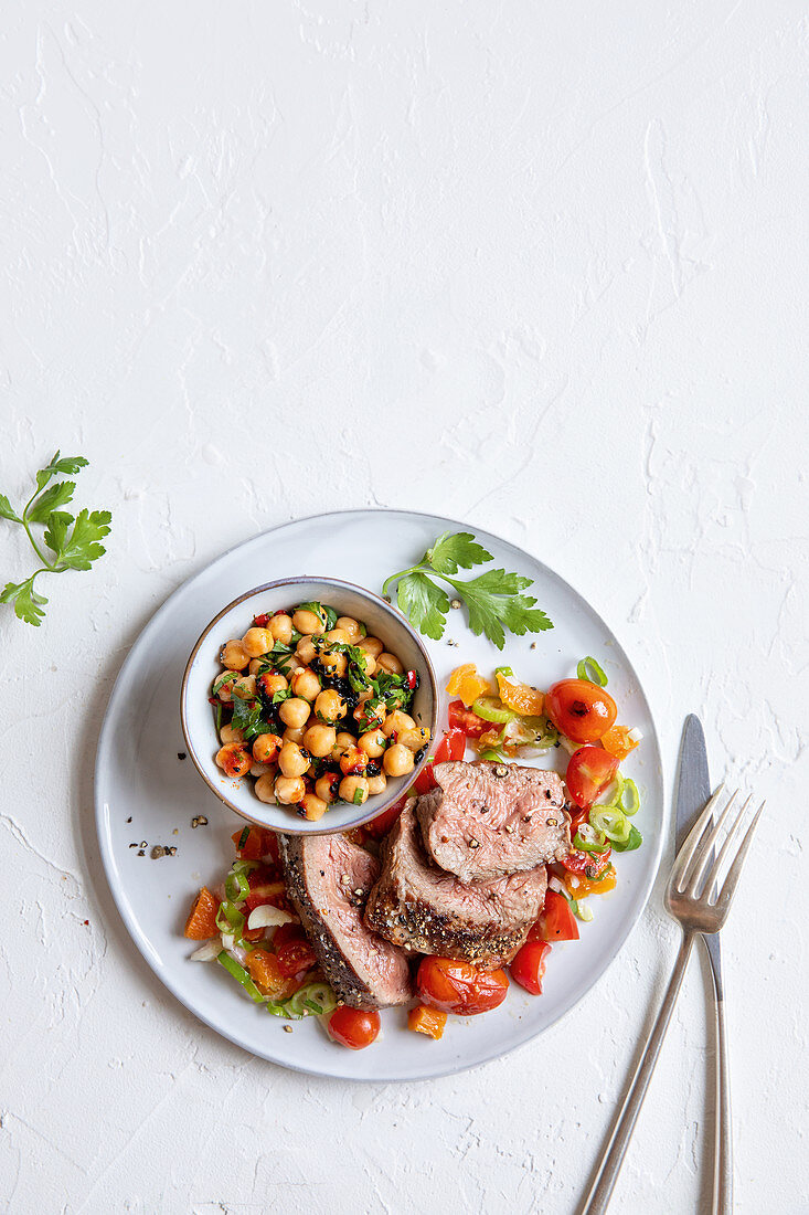 Lamb with chickpeas and a tomato salad