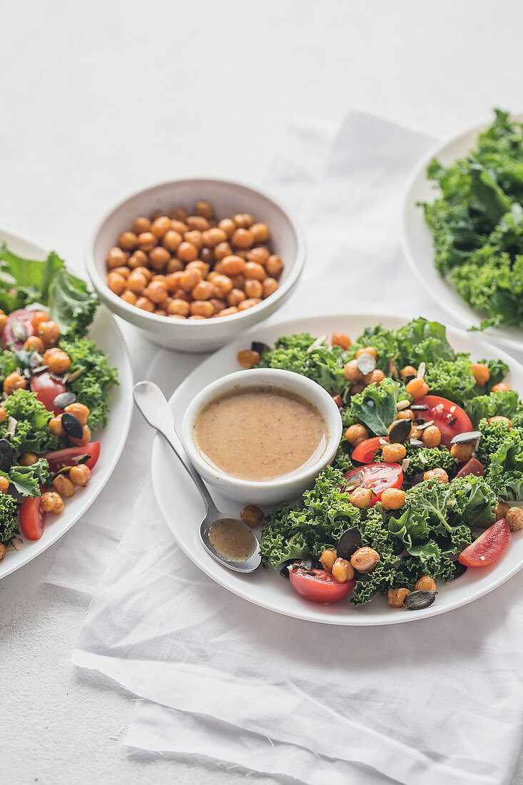 Salad with roasted chicpeas, tomatoes, kale and mustard vinaigrette sauce