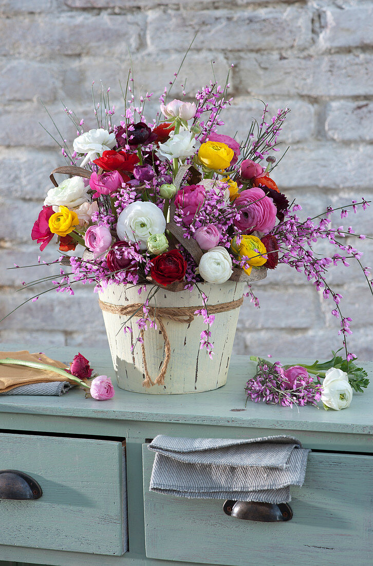 Lush spring bouquet of ranunculus and broom