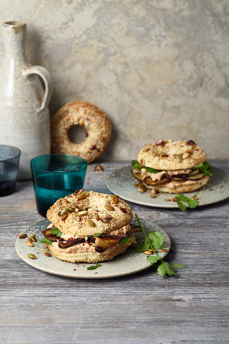 Nut and sesame seed bagels with hummus and roasted aubergines