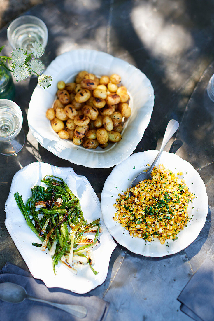 Foil-wrapped baby potatoes, Charred spring onions, Herby corn off the cobs in brown butter sauce