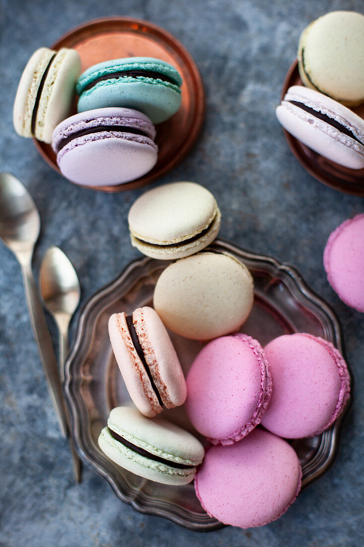 Assorted delectable macarons placed on pink table