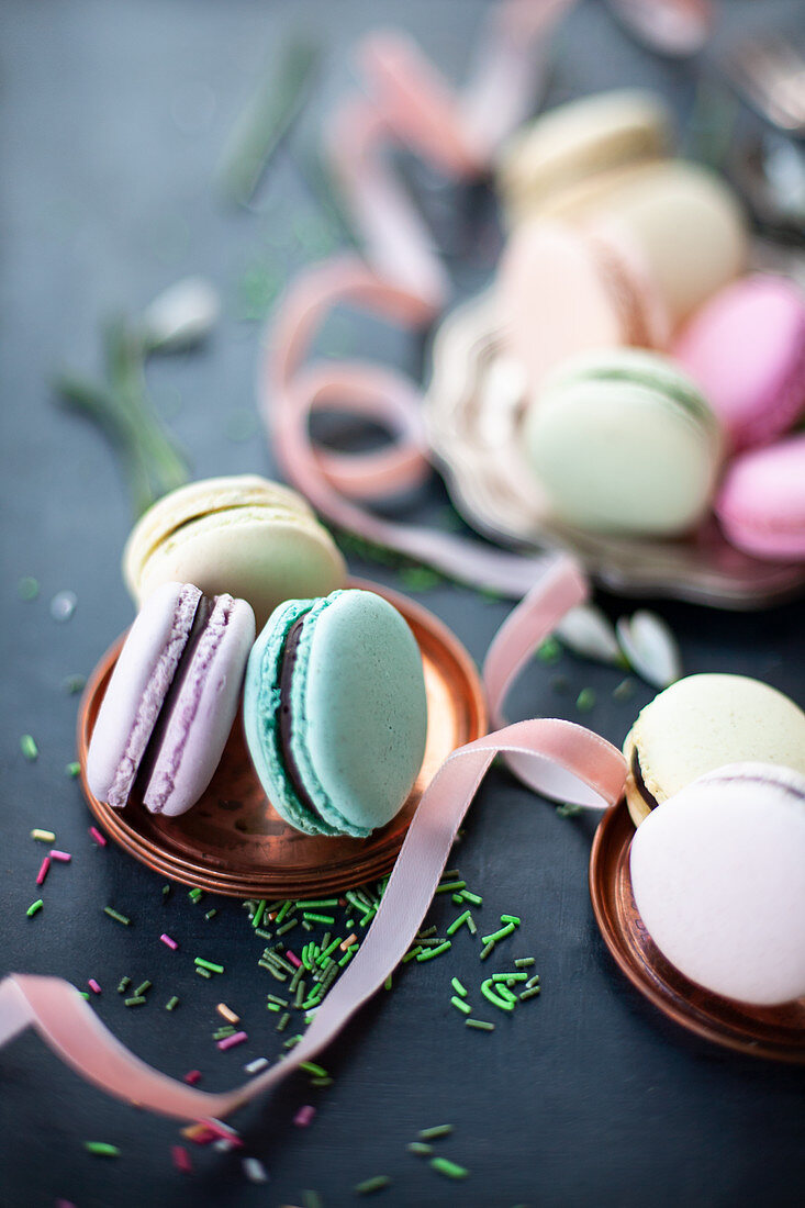 Assorted delectable macarons placed on pink table