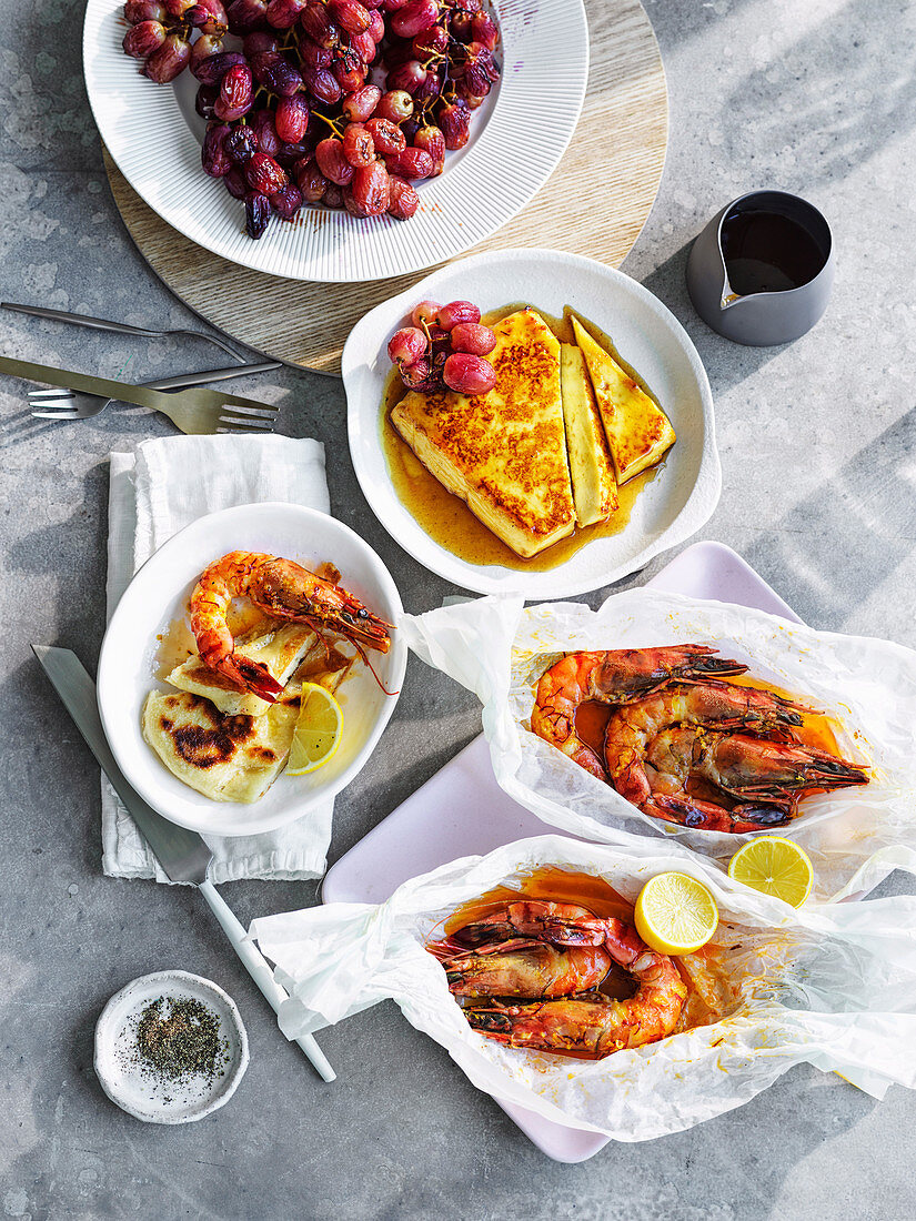 Haloumi with roast grapes and honey and Baked tiger prawns with saffron butter
