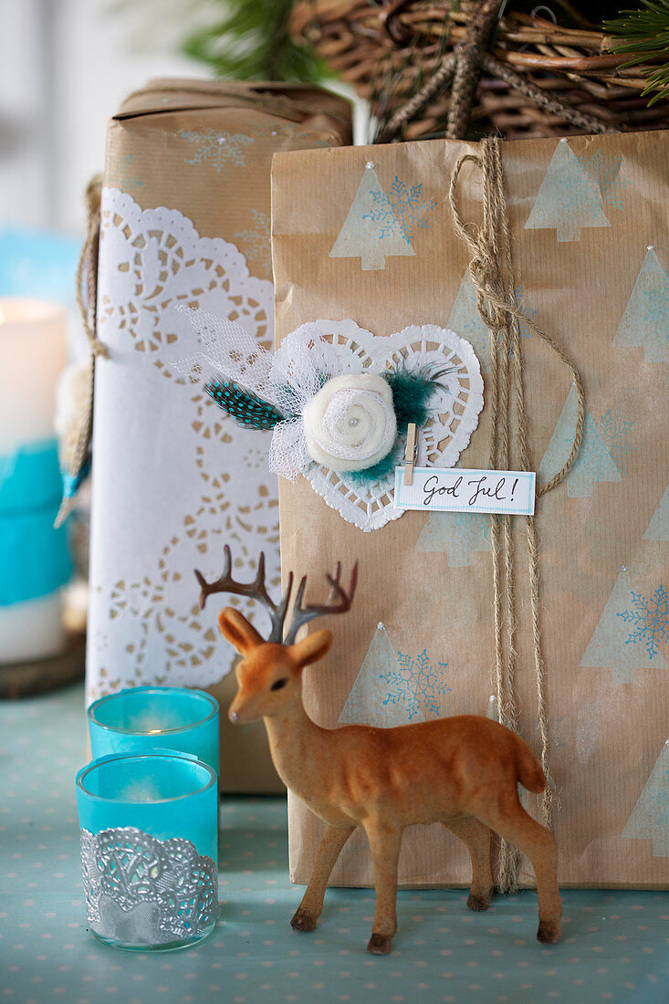 DIY Christmas wrapping decorated with doilies with a deer figure and lanterns in the foreground