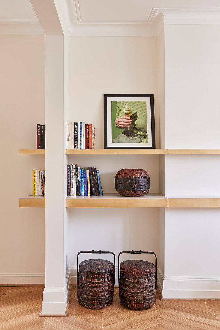 Books and ornaments on wooden shelves