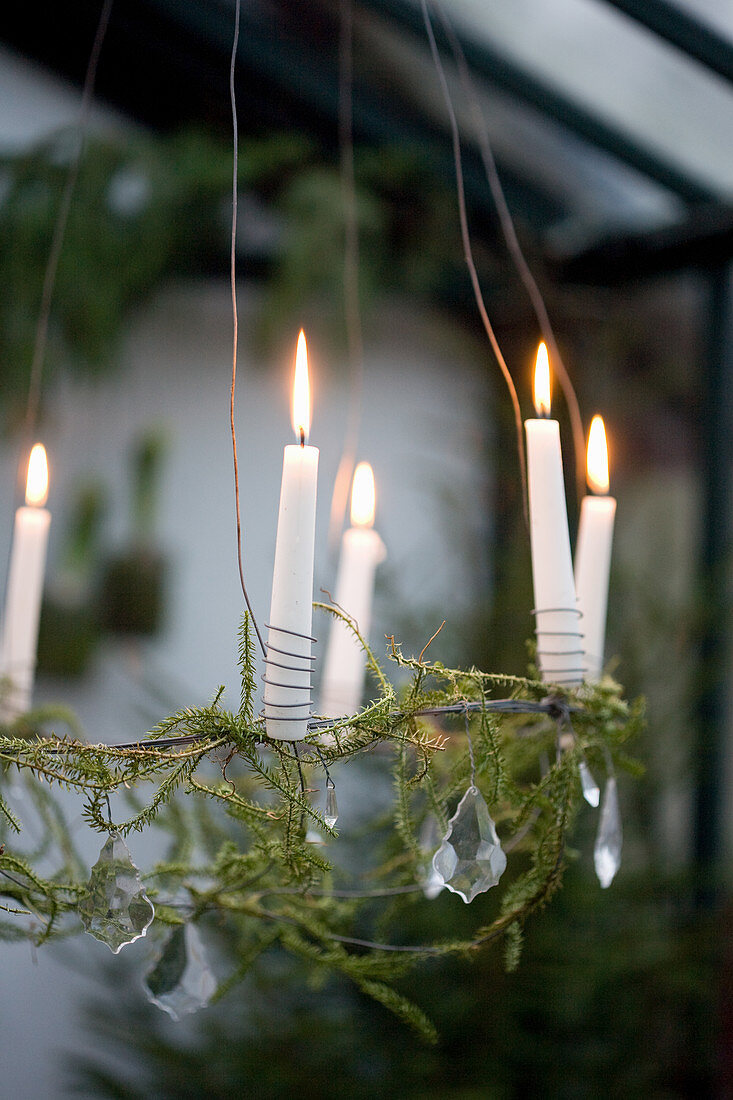 Suspended wreath decorated with glass beads and candles