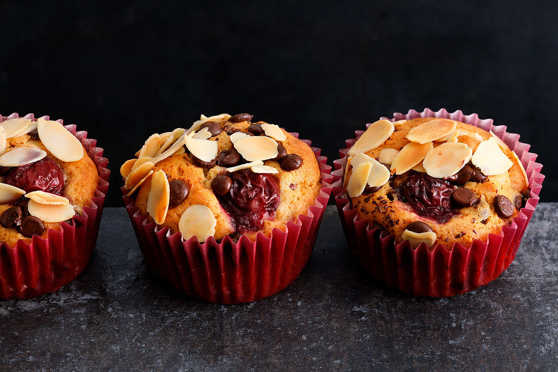 Cherry muffins with chocolate chips and flaked almonds