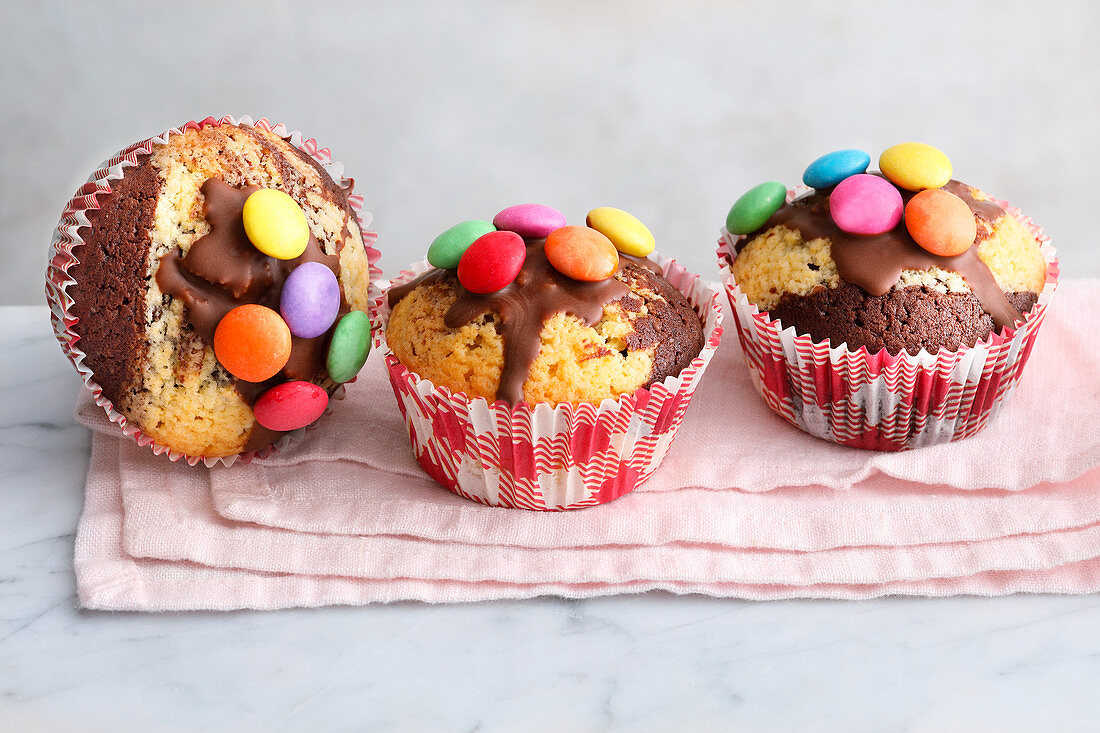 Marble cake muffins decorated with colourful chocolate beans
