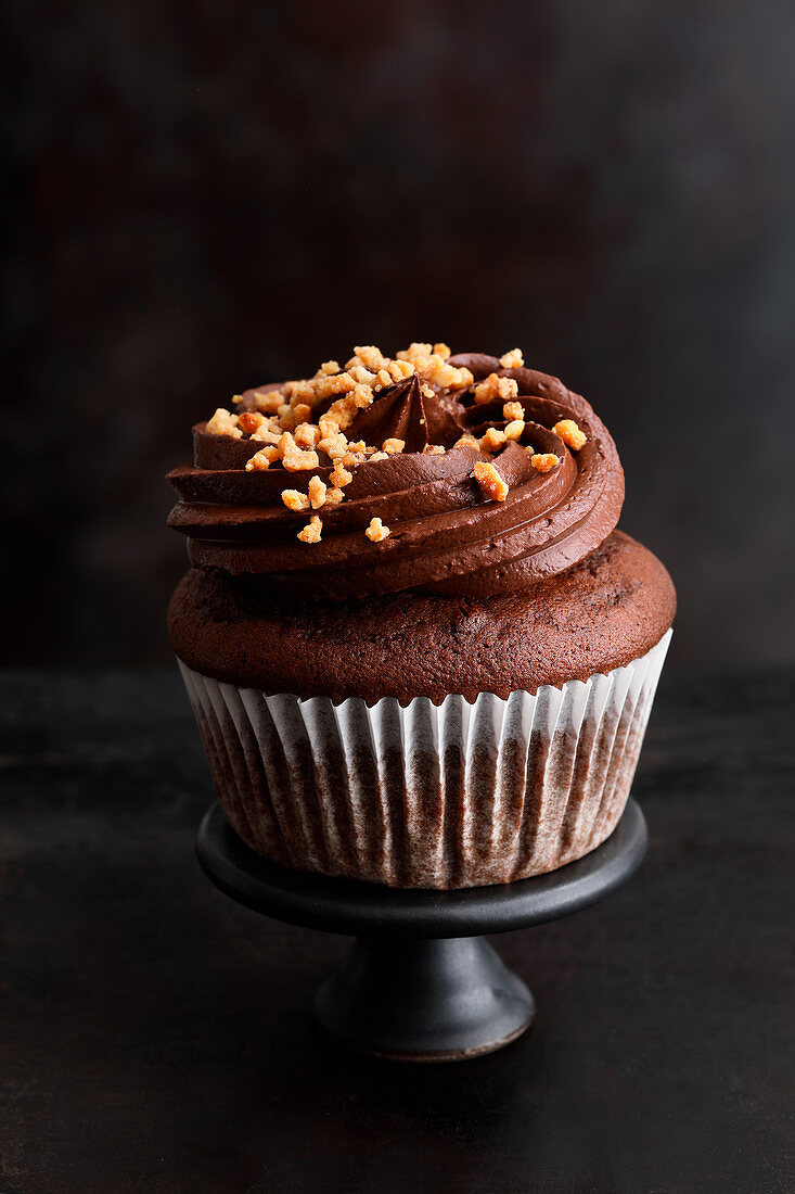 A chocolate chip cupcake with a brittle topping