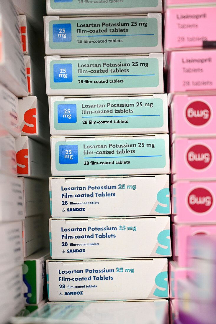 Stack of losartan potassium blood pressure tablet boxes