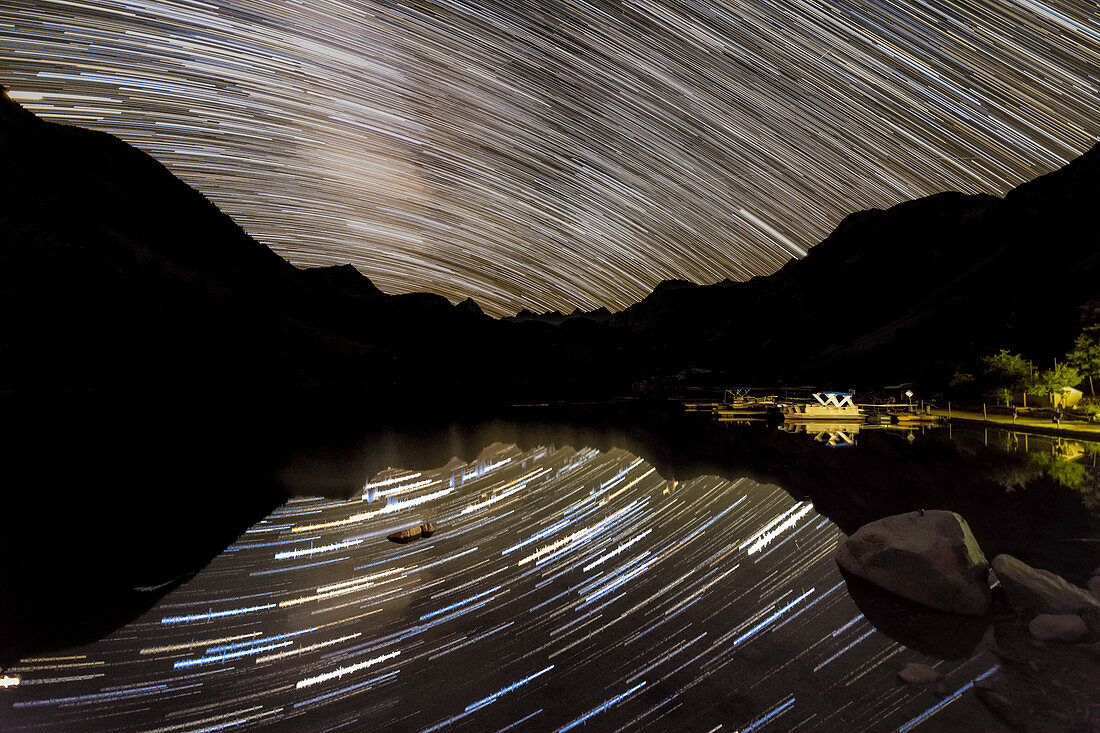 Star trails reflected in mountain lake