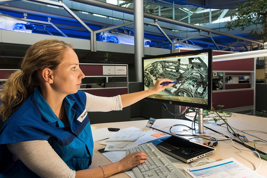 Worker pointing at a car design