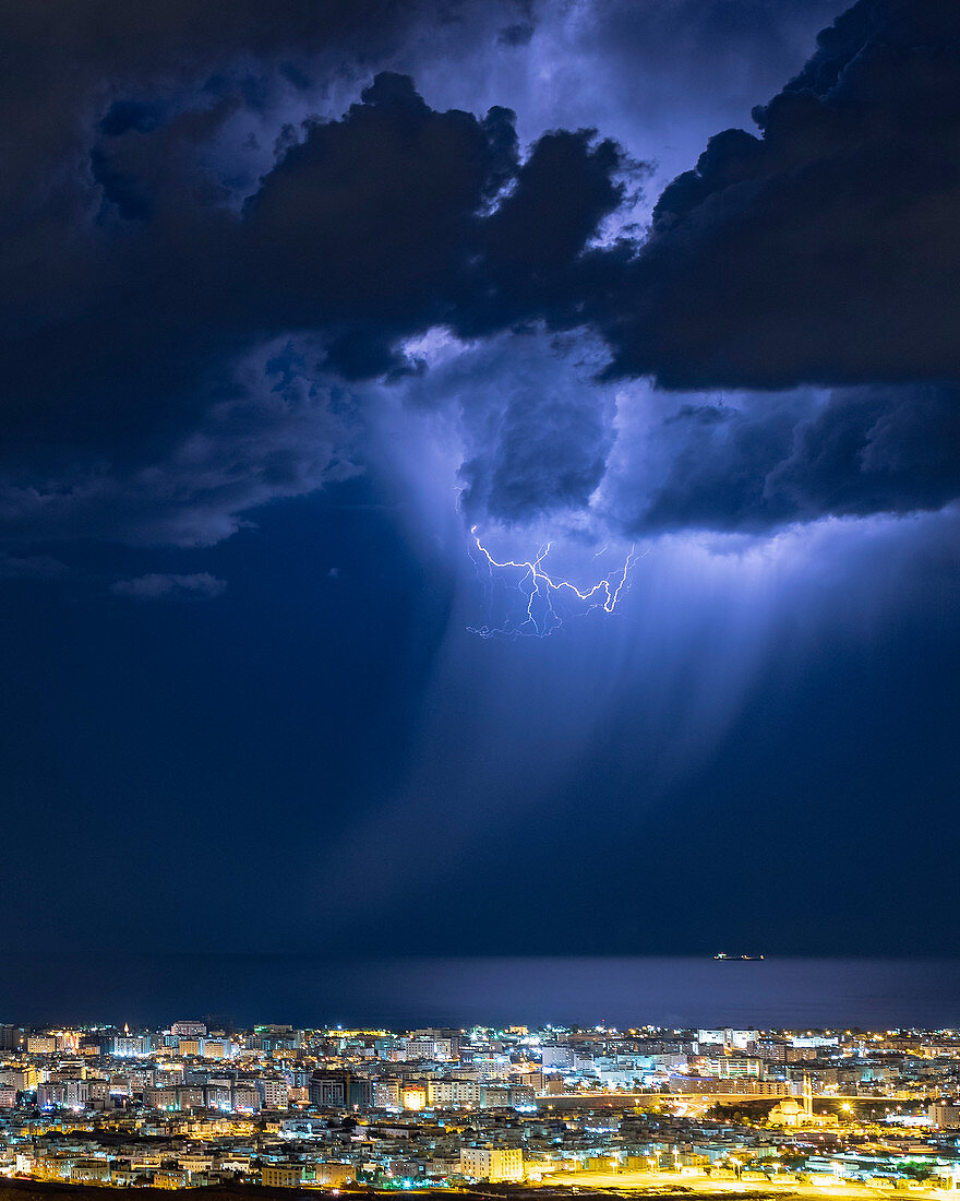 Lightning over a coastal town