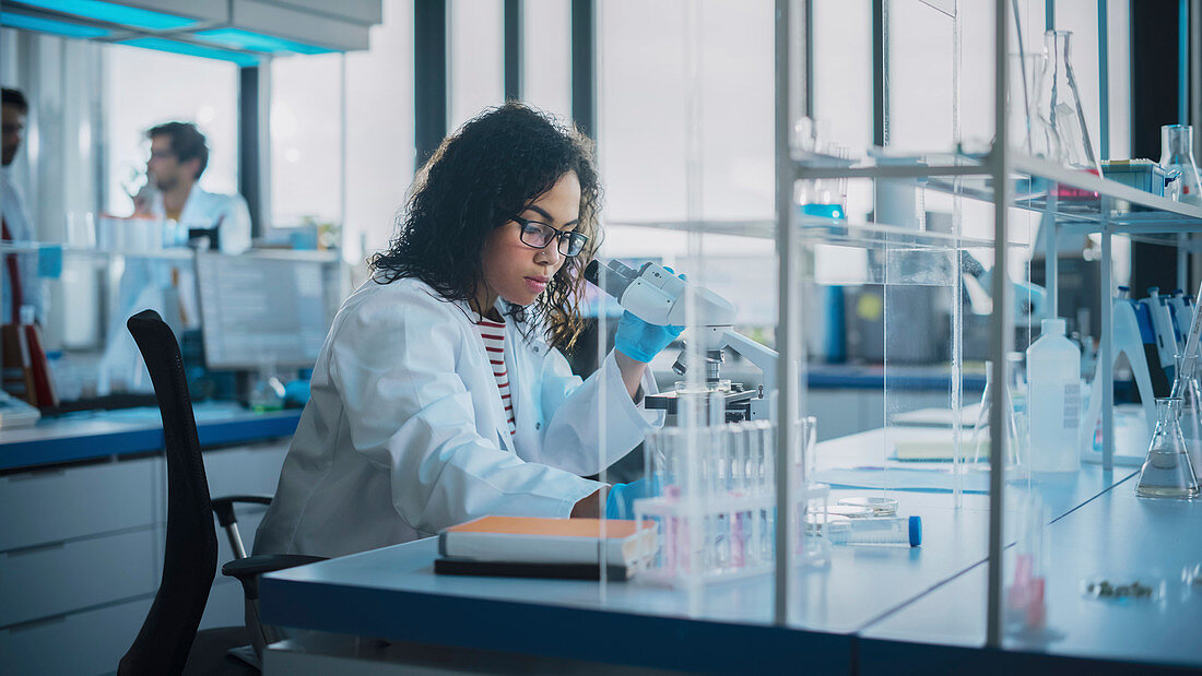 Team of young scientists working in laboratory