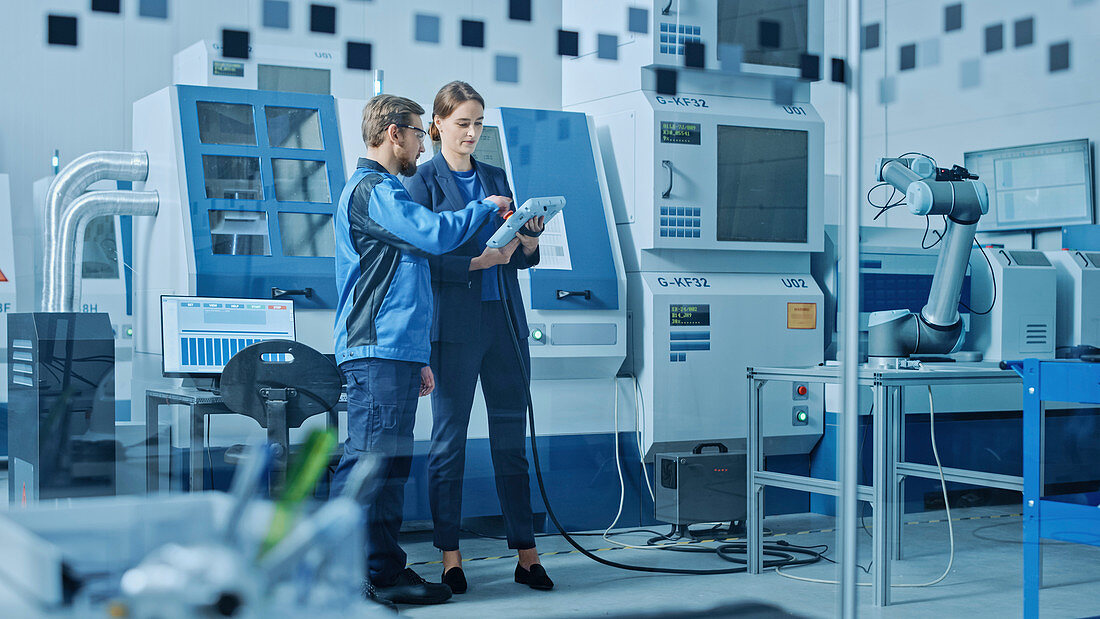 Engineer and machinery operator using a tablet computer