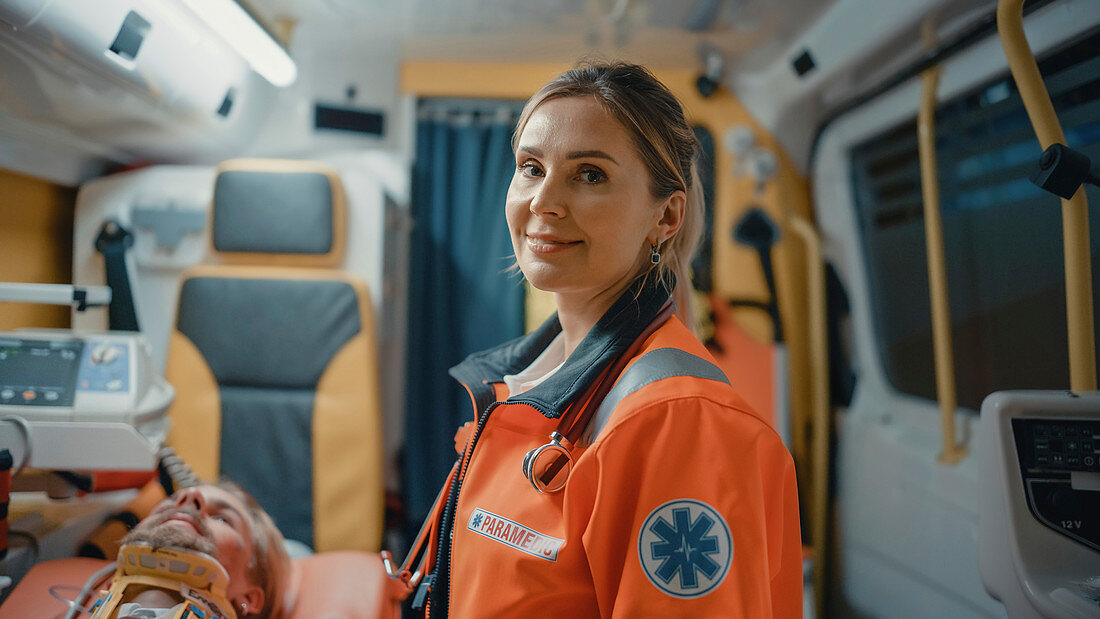 Paramedic smiles in ambulance