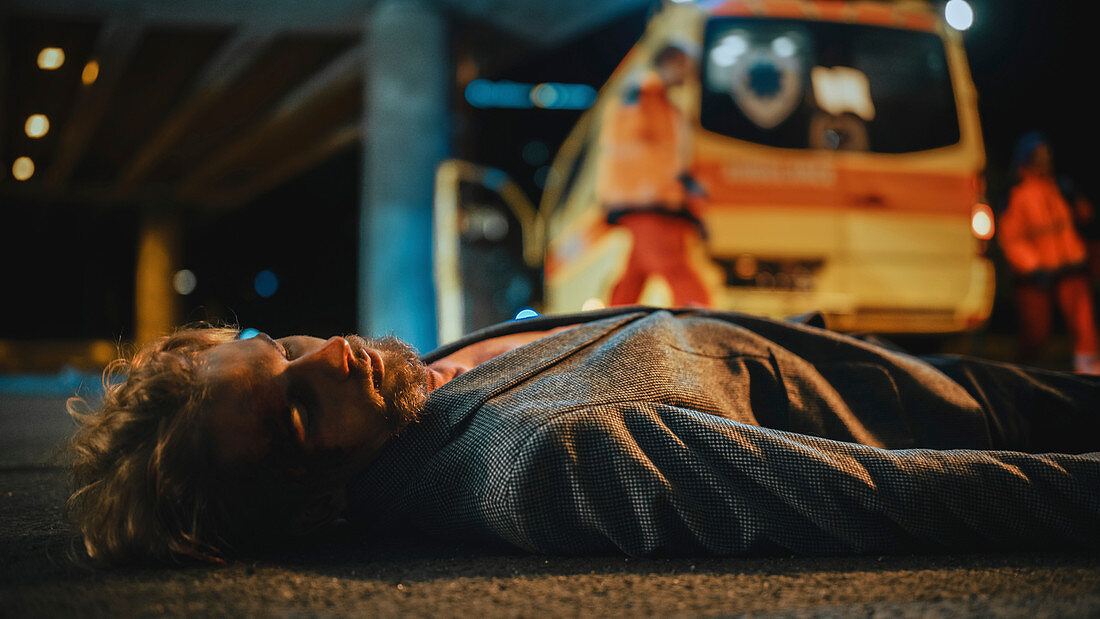 Man lying on the pavement after traffic accident