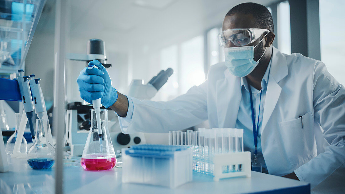 Scientist pipetting samples