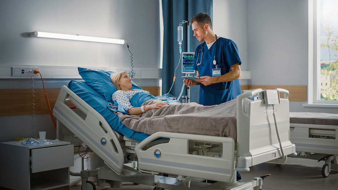 Nurse talking to patient on hospital ward