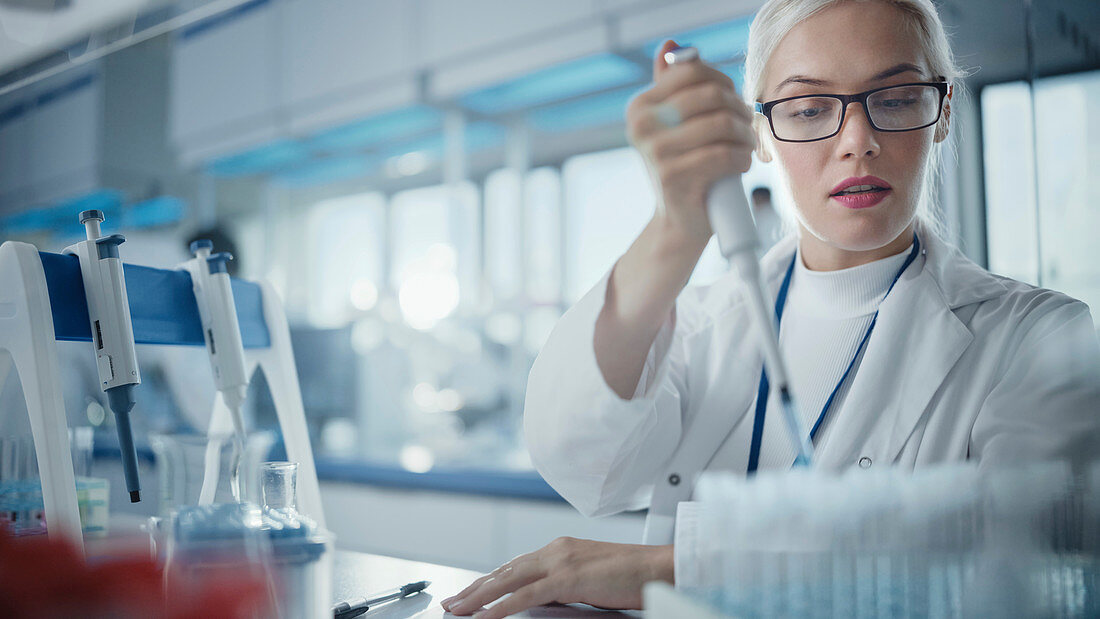 Scientist using a micropipette