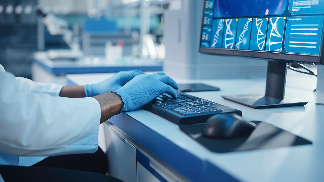 Scientist typing on a keyboard