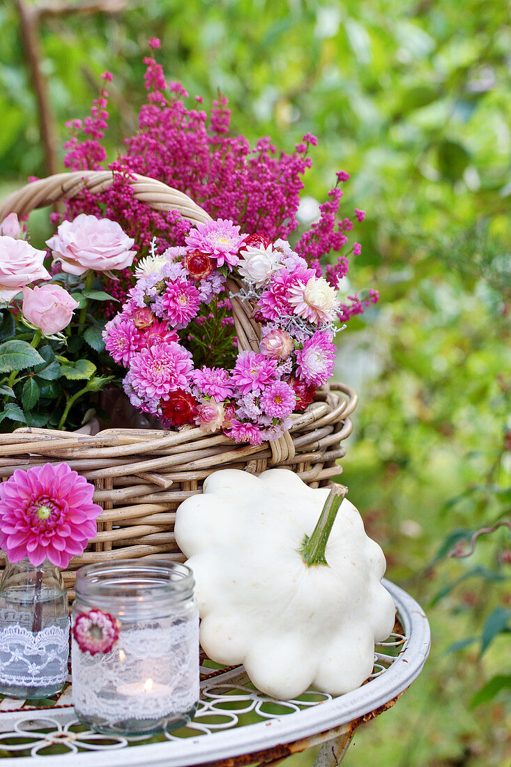 Autumn decoration with roses, potters, flower wreaths, dahlia blossoms, and patty pan squash