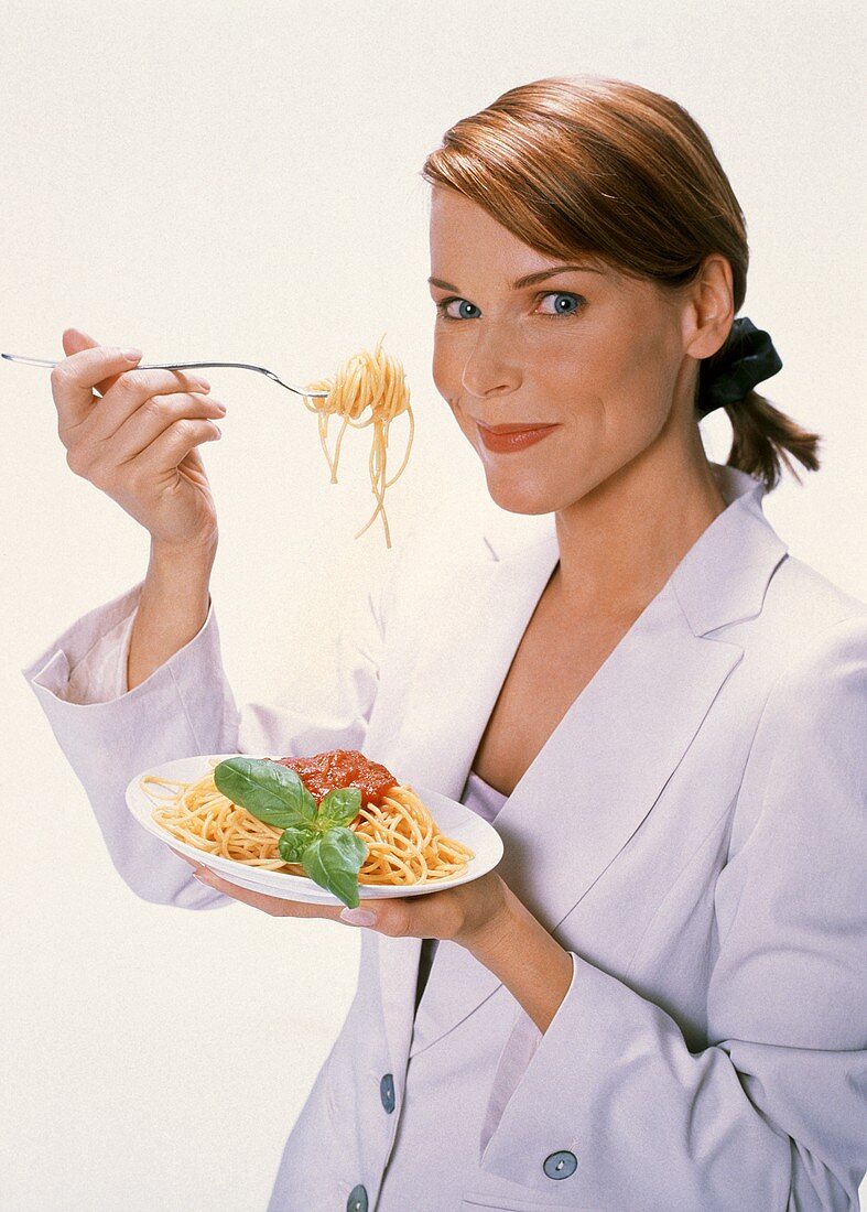Woman Eating Spaghetti with Tomato Sauce