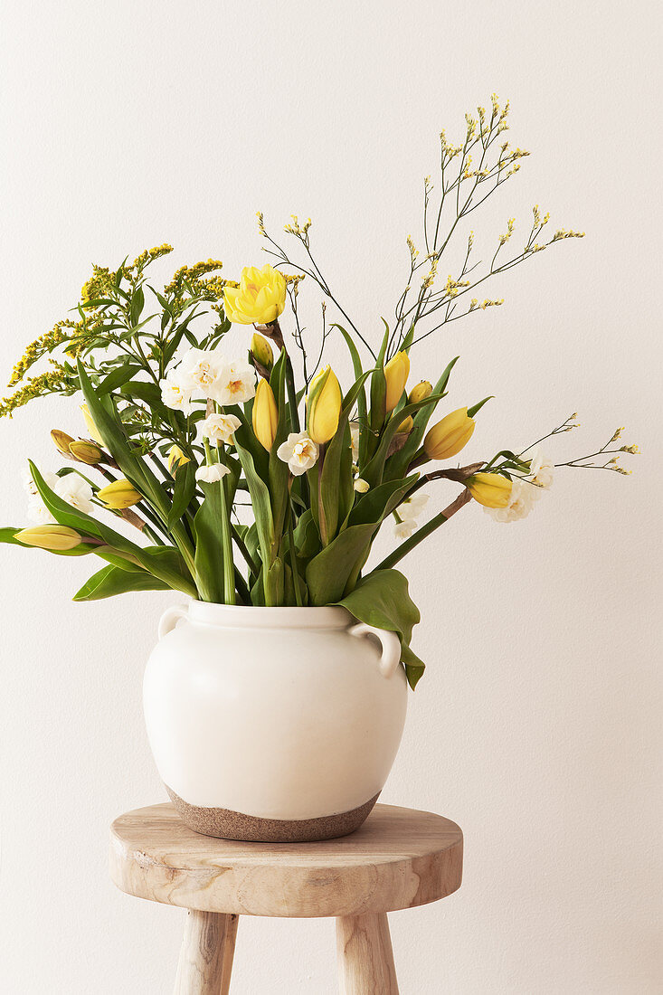 Spring bouquet with tulips, daffodils, goldenrod, and sea lavender
