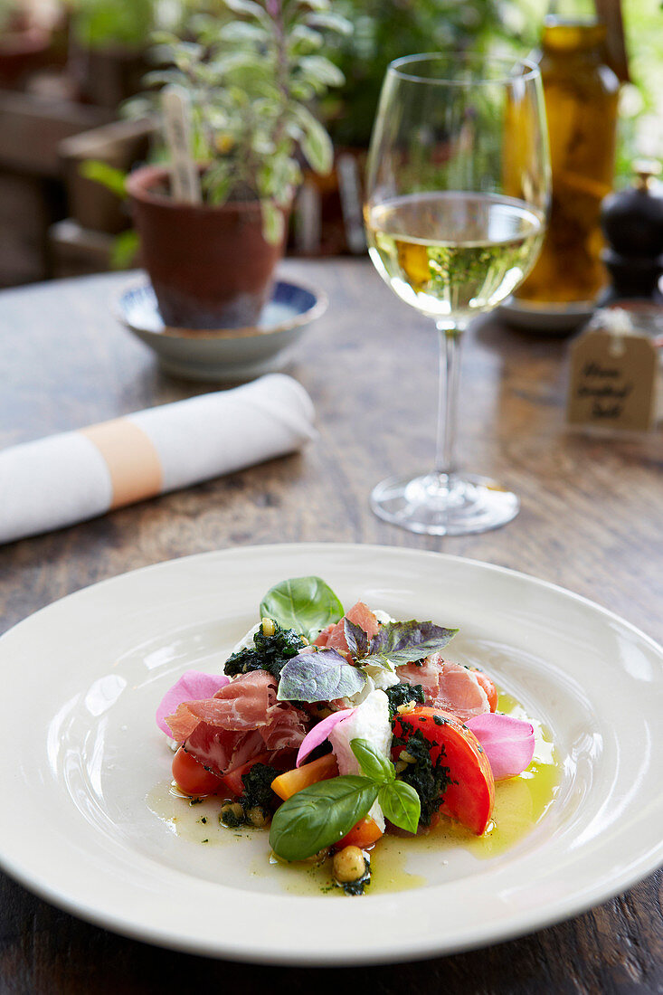 Garden tomato, bresaola and rosemary goat s cheese salad with purple basil