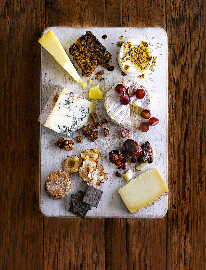 Cheese platter with pear crisps, candies walnuts and chorizo-stuffed dates