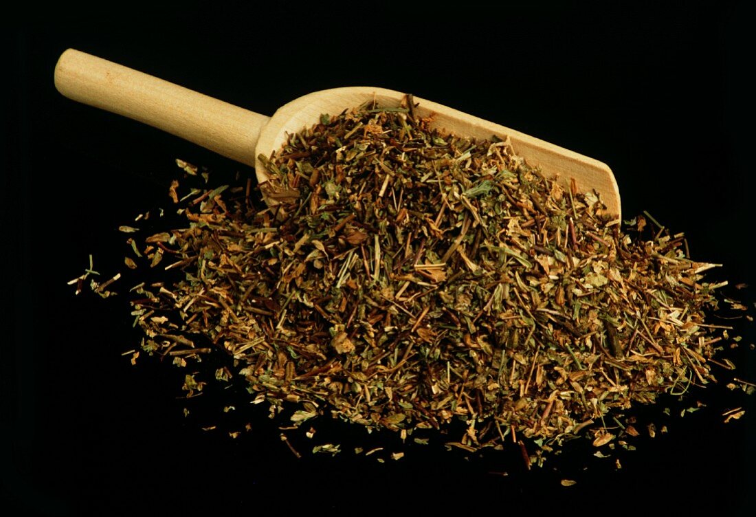 Dried eyebright on wooden scoop