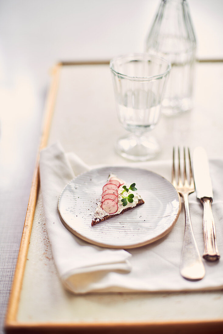Pumpernickel canapes with cream cheese, cress and radishes