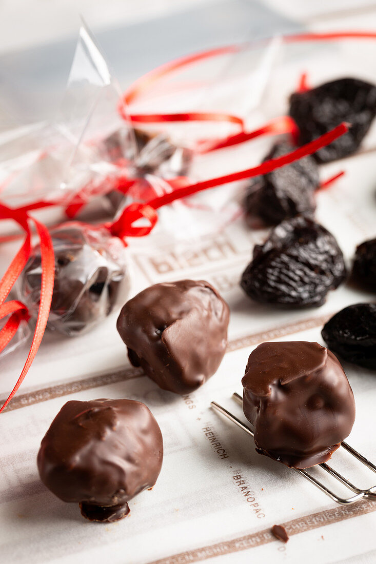 Dried plums with chocolate icing as an edible Christmas decoration