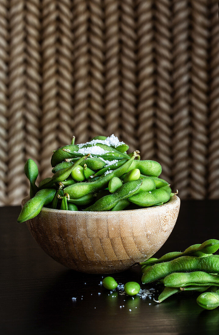 Fresh soybeans with sea salt in a wooden bowl