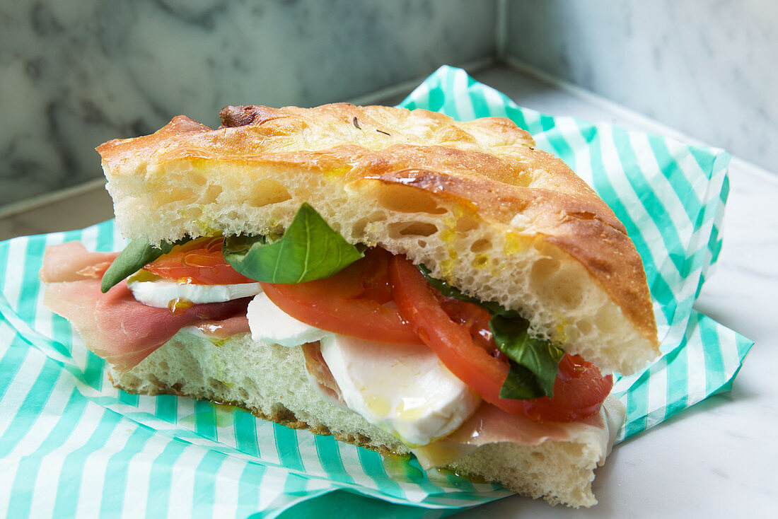 Deli sandwich with ham, tomatoes and mozzarella