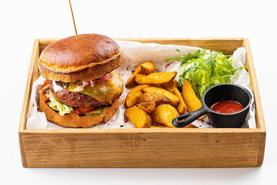 American beef burger with potato wedges and tomato sauce