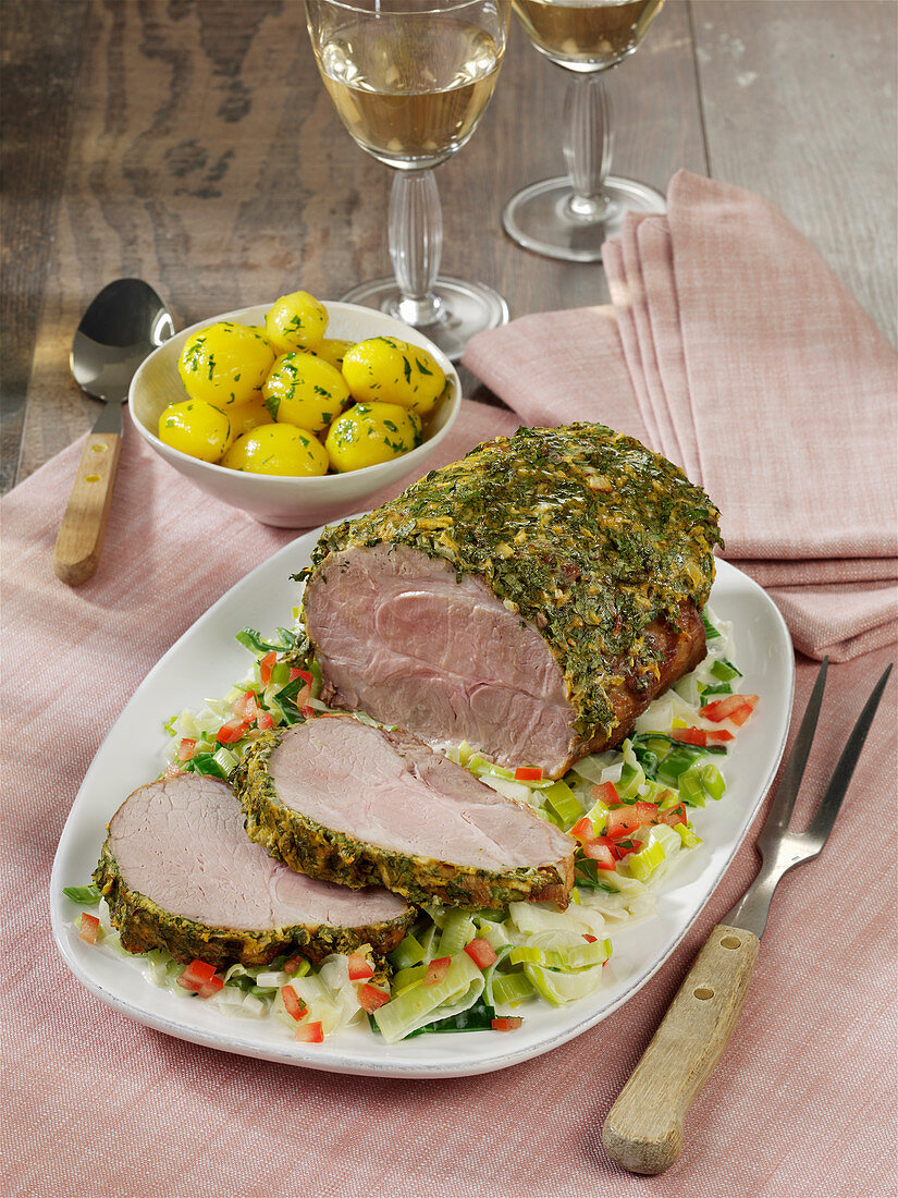 Pork neck roast with onion and herb crust with tomato risotto