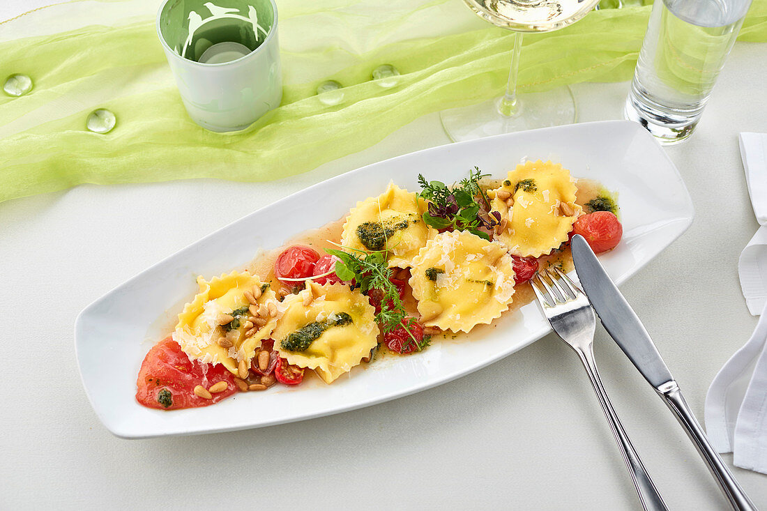 Ravioli mit geschmolzenen Tomaten, Kräutern und Pinienkernen