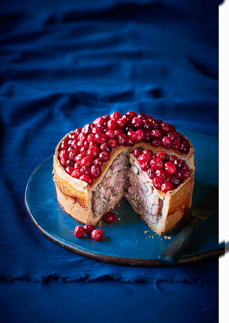 Chicken and pork pie topped with cranberries