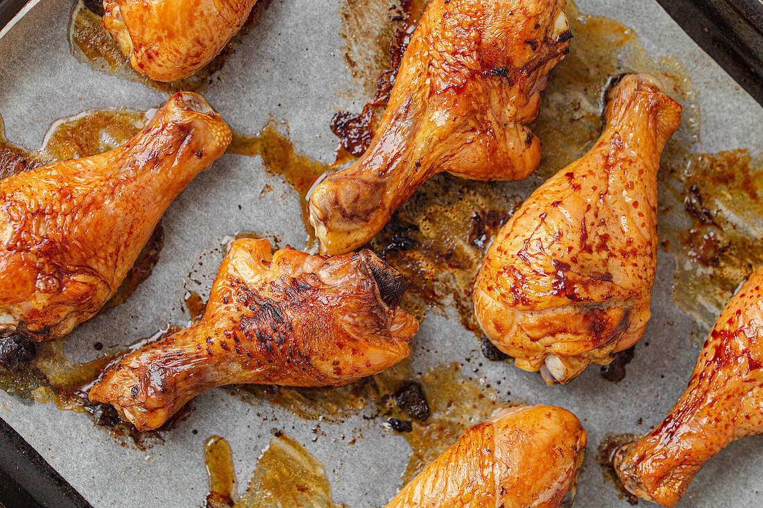 Roasted chicken drumsticks on baking paper