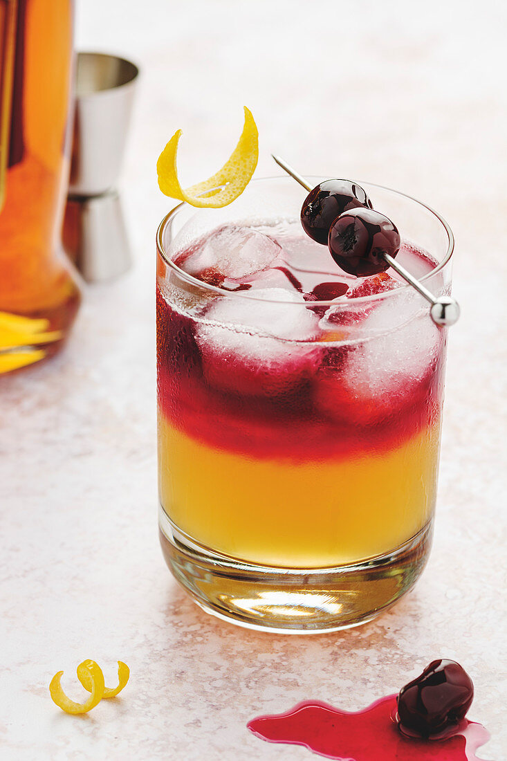 New York Whiskey sour in a glass with ice cubes and syrup