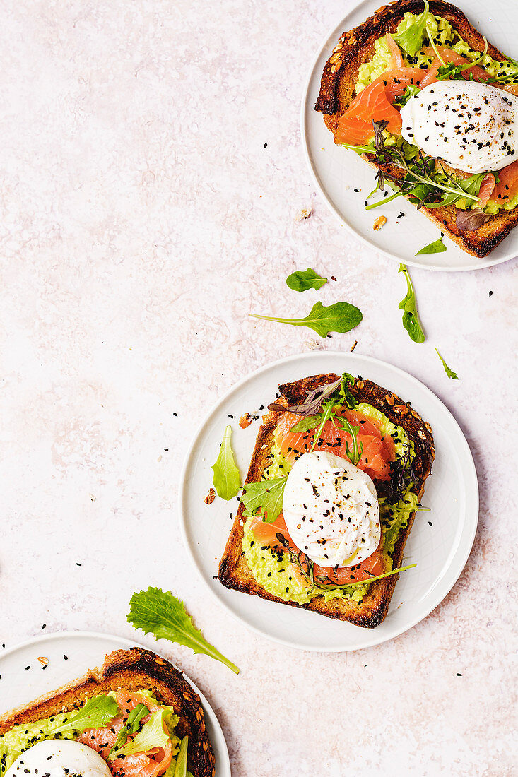 Smoked salmon toasts with avocado cream and poached eggs