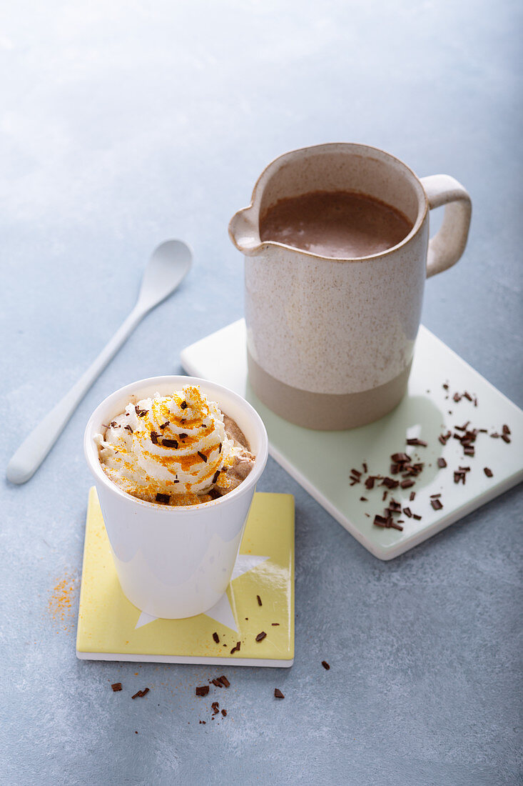 Hot turmeric chocolate topped with cream