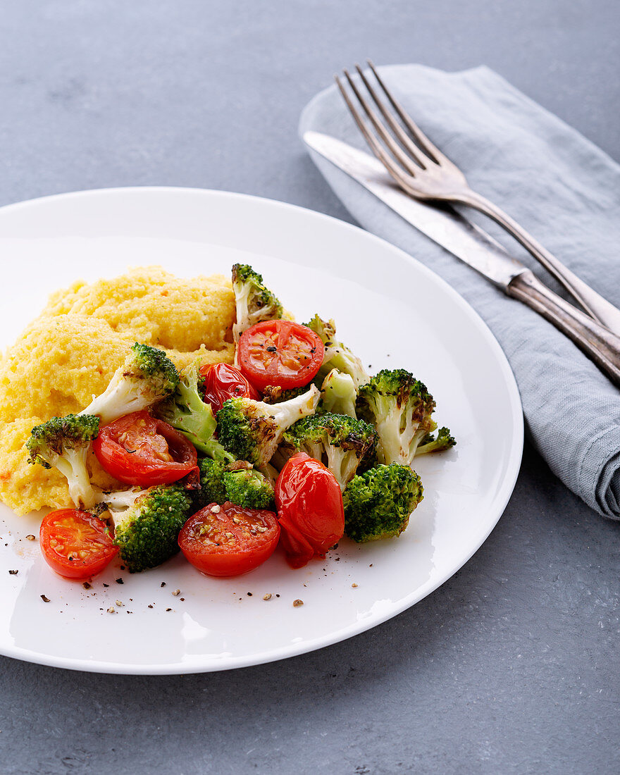 Sautéed broccoli with braised tomatoes and cheese polenta