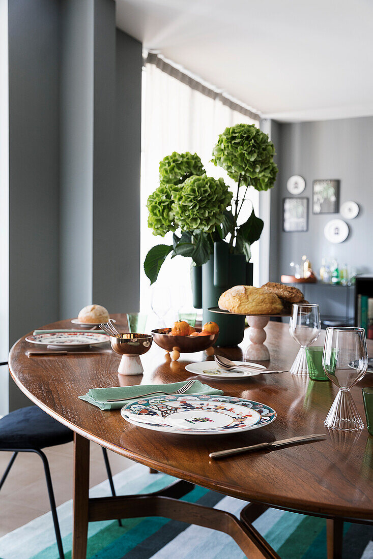 Covered, oval dining table in open living room