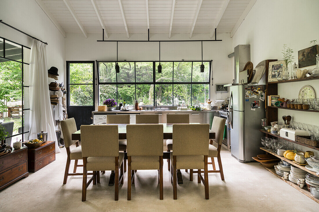 Dining area in open kitchen with wallmounted shelves