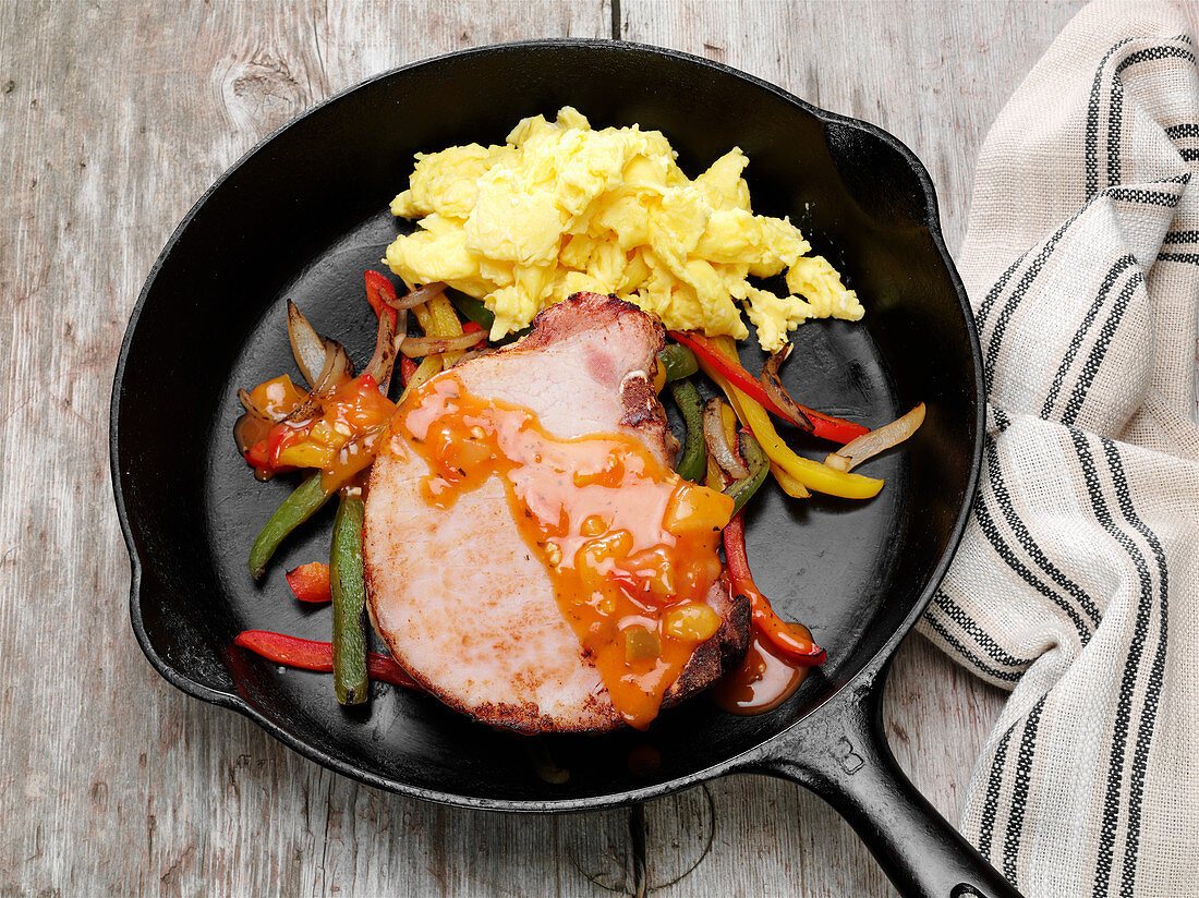 Smoked pork chop, bell peppers and fajita style sauce with scrambled eggs